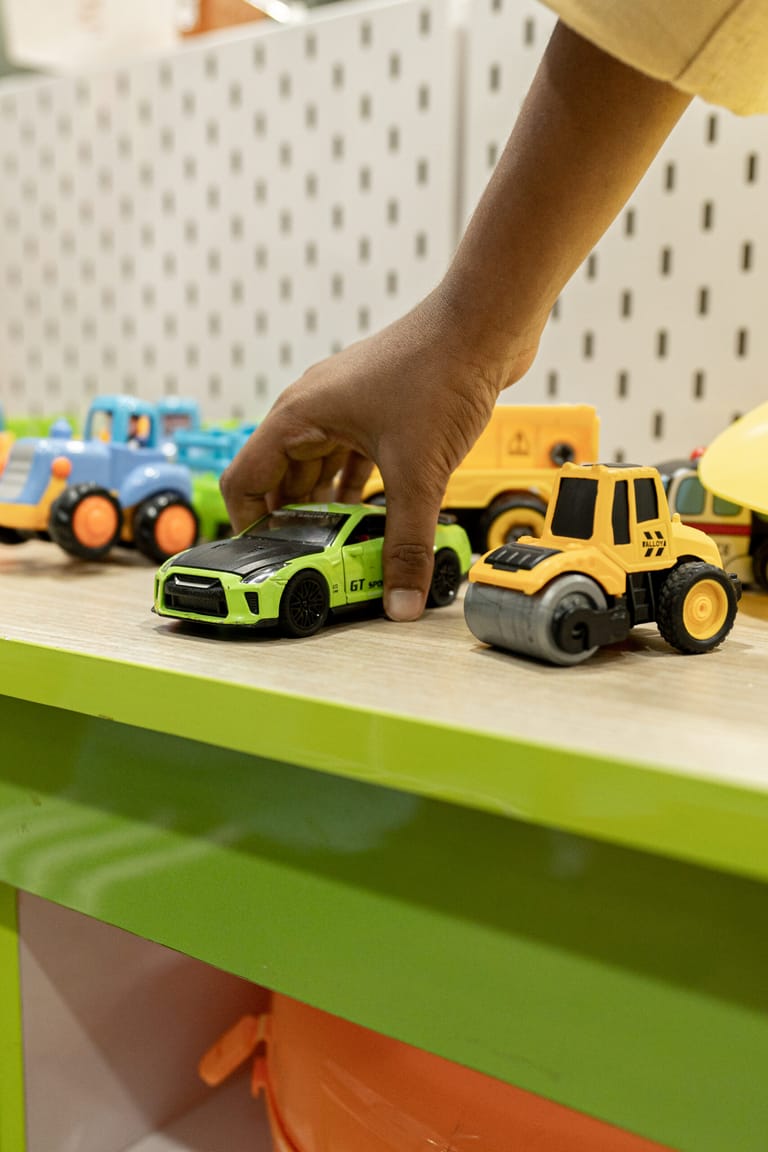 Toy vehicles lined up on a shelf